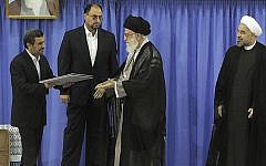 Mahmoud Ahmadinejad, left, delivers the official seal of approval of Supreme Leader Ayatollah Ali Khamenei, center, to give to President Hassan Rouhani, right, in an official endorsement ceremony, in Tehran, Iran, August 3, 2013. (photo credit: AP/Office of the Iranian Supreme Leader)