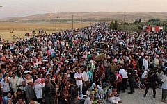 Thousands of Syrian refugees crossing into Iraq on August 15, 2013. (photo credit: AP/HO)