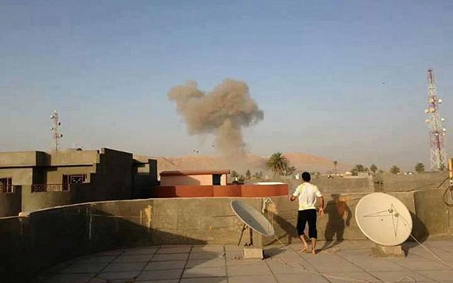 Smoke rises after a bomb attack in Tuz Khormato, 130 miles (210 kilometers) north of Baghdad, Iraq, Saturday, Aug. 10, 2013 (photo credit: AP) Smoke rises after a bomb attack in Tuz Khormato, 130 miles (210 kilometers) north of Baghdad, Iraq, Saturday, Aug. 10, 2013 (photo credit: AP)