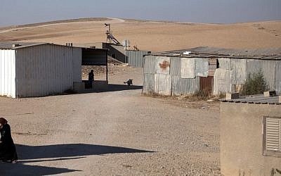 A Bedouin woman walks through the village of al-Sira, Israel, on Wednesday. (photo credit: AP/Sebastian Scheiner)
