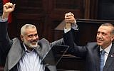 Ismail Haniyeh, Hamas premier in Gaza, left, and his Turkish counterpart, then-PM Recep Tayyip Erdogan, salute lawmakers and supporters of Erdogan's Islamist Justice and Development Party at the Parliament in Ankara, Turkey, January 3, 2012. (AP)