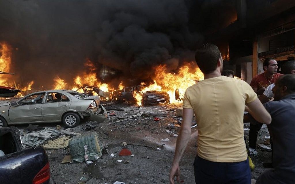 Lebanese citizens gather at the site of a car bomb explosion in southern Beirut, Lebanon, on Thursday, August 15, 2013. (photo credit: AP/Hussein Malla)