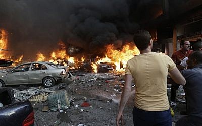 Lebanese citizens gather at the site of a car bomb explosion in southern Beirut, Lebanon, on Thursday, August 15, 2013. (photo credit: AP/Hussein Malla)