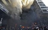 Smoke pours from buildings after a bomb attack in Beirut Thursday. (photo credit: AP/Hussein Malla)