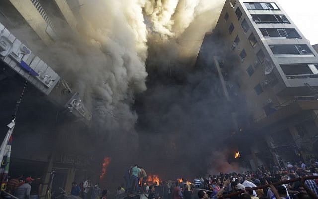 Smoke pours from buildings after a bomb attack in Beirut Thursday. (photo credit: AP/Hussein Malla) Smoke pours from buildings after a bomb attack in Beirut Thursday. (photo credit: AP/Hussein Malla)