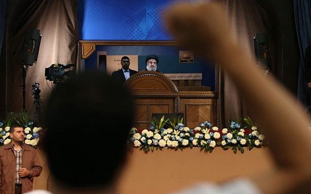 A Hezbollah supporter raises his fist and chants slogans, as Hezbollah leader Sheikh Hassan Nasrallah, center, speaks during a rally to mark Jerusalem day or al-Quds day, in a southern suburb of Beirut, Lebanon, Friday. (AP Photo/Hussein Malla) A Hezbollah supporter raises his fist and chants slogans, as Hezbollah leader Sheikh Hassan Nasrallah, center, speaks during a rally to mark Jerusalem day or al-Quds day, in a southern suburb of Beirut, Lebanon, Friday. (AP Photo/Hussein Malla)
