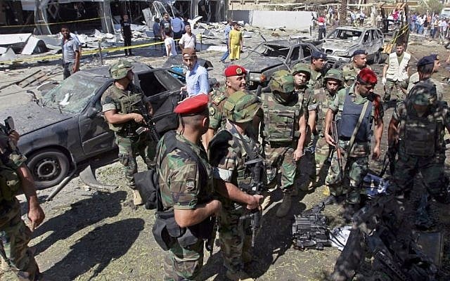 Lebanese Army soldiers at the site of a car bomb explosion outside the Salam Mosque, in the northern city of Tripoli, Lebanon, on August 24, 2013 (photo credit: AP/Bilal Hussein)