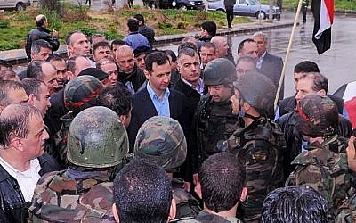 Undated photo posted on Syrian President Bashar Assad's official Instagram account showing Assad visiting with soldiers in Baba Armr, Homs province. (photo credit: AP/Syrian Presidency via Instagram)
