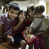 Children whose families fled their homes because of Syria’s civil war pose at the Kertaj Hotel in Damascus, Syria. Thousands of Syrians have taken refuge in the capital from fighting around their hometowns. (Photo credit: AP/Hassan Ammar) Children whose families fled their homes because of Syria’s civil war pose at the Kertaj Hotel in Damascus, Syria. Thousands of Syrians have taken refuge in the capital from fighting around their hometowns. (Photo credit: AP/Hassan Ammar)