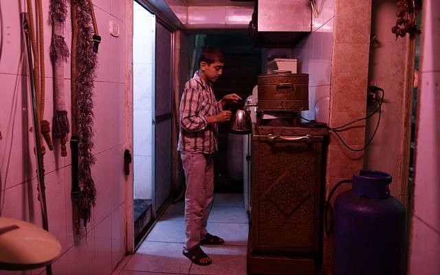 In this Sunday, Aug. 25, 2013, photo, a Syrian youth who fled his home because of Syria’s civil war prepares tea in the kitchen of the Kertaj Hotel in Damascus, Syria. Thousands of Syrians have taken refuge in the capital from fighting around their hometowns. Around a dozen families living for months in the Kertaj Hotel and say it has become like a home to them. (Photo credit: AP/Hassan Ammar) In this Sunday, Aug. 25, 2013, photo, a Syrian youth who fled his home because of Syria’s civil war prepares tea in the kitchen of the Kertaj Hotel in Damascus, Syria. Thousands of Syrians have taken refuge in the capital from fighting around their hometowns. Around a dozen families living for months in the Kertaj Hotel and say it has become like a home to them. (Photo credit: AP/Hassan Ammar)