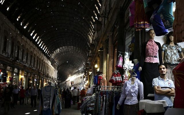 A Syrian shopkeeper waits for customers at the popular Hamidiyeh old market, in Damascus, Thursday, August 22, 2013. (photo credit: AP/Hassan Ammar) A Syrian shopkeeper waits for customers at the popular Hamidiyeh old market, in Damascus, Thursday, August 22, 2013. (photo credit: AP/Hassan Ammar)