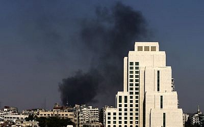 Black columns of smoke rise from heavy shelling in the Jobar neighborhood in East of Damascus, Syria, Sunday, August 25, 2013. (photo credit: AP/Hassan Ammar)