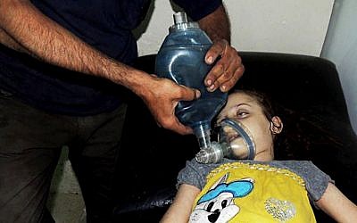 A Syrian girl receives treatment at a makeshift hospital in Arbeen town, Damascus, Syria, on August 21, 2013 (photo credit: AP/Local Committee of Arbeen)