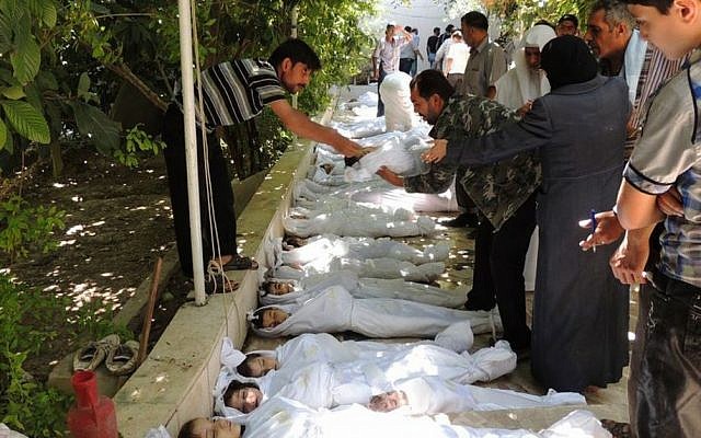 This citizen journalism image provided by the Local Committee of Arbeen which has been authenticated based on its contents and other AP reporting, shows Syrian citizens trying to identify dead bodies, after an alleged poisonous gas attack fired by regime forces, according to activists in Arbeen town, Damascus, Syria, Wednesday, Aug. 21, 2013. (Photo credit: AP /Local Committee of Arbeen) This citizen journalism image provided by the Local Committee of Arbeen which has been authenticated based on its contents and other AP reporting, shows Syrian citizens trying to identify dead bodies, after an alleged poisonous gas attack fired by regime forces, according to activists in Arbeen town, Damascus, Syria, Wednesday, Aug. 21, 2013. (Photo credit: AP /Local Committee of Arbeen)