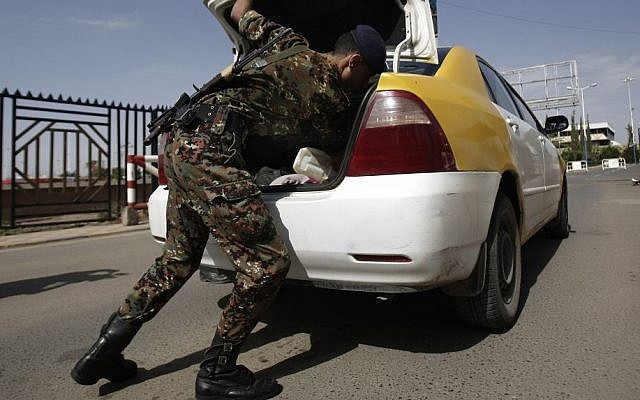 A policeman checks a car at the entrance of Sanaa International Airport, in Yemen, Wednesday, Aug. 7, 2013. (photo credit: AP/Hani Mohammed)
