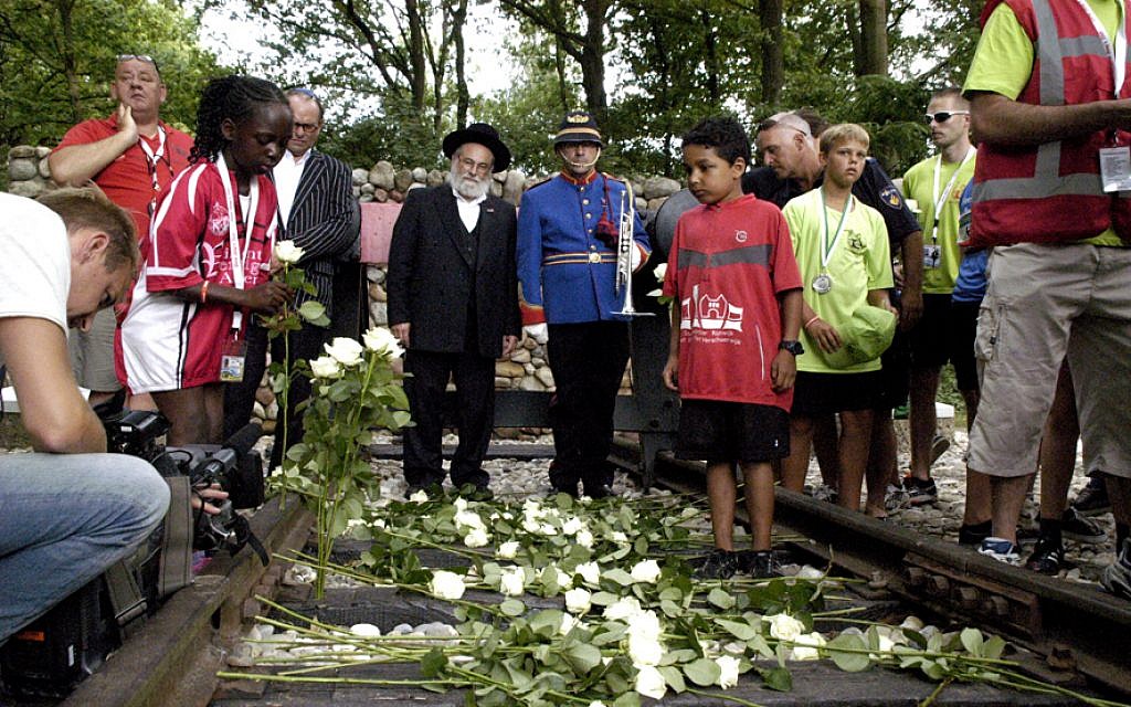 Cheider spokesman Rabbi Binyomin Jacobs with non-Jewish Dutch students at the site of the Westerbork concentration camp, July 2013. (Courtesy of the office of Rabbi Binyomin Jacobs and Ome Joop's Tour/JTA) Cheider spokesman Rabbi Binyomin Jacobs with non-Jewish Dutch students at the site of the Westerbork concentration camp, July 2013. (Courtesy of the office of Rabbi Binyomin Jacobs and Ome Joop's Tour/JTA)