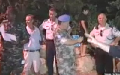 UNIFIL personnel inspect rocket damage at Kibbutz Gesher Haziv on Thursday night (photo credit; Channel 2 screenshot)