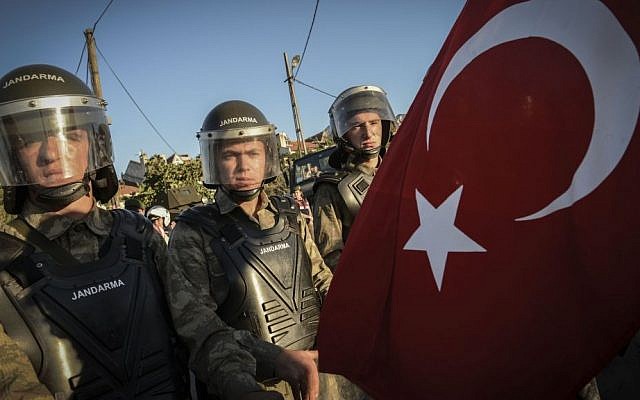 Paramilitary police officers blocks a man holding a national flag outside the Silivri jail complex in Silivri, Turkey (illustrative photo credit: AP) Paramilitary police officers blocks a man holding a national flag outside the Silivri jail complex in Silivri, Turkey (illustrative photo credit: AP)