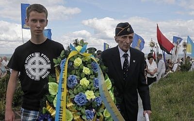 Yevhen Kutsik, 86, former soldier of SS Galician Division, right, and a young Ukrainian nationalist lay a wreath on a monument to SS Galician Division, Sunday, July 21, 2013. (photo credit:AP/Efrem Lukatsky)