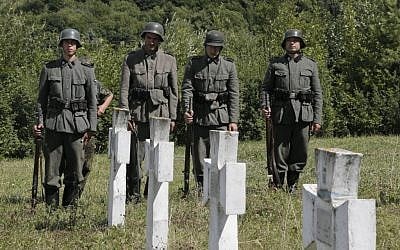 Ukrainians dressed in the SS Galician Division uniform stand in the guard of honor during re-burial ceremony at the SS Galician Division cemetery near the village of Chervone in western Ukraine on Sunday, July 21, 2013. (photo credit: AP/Efrem Lukatsky)