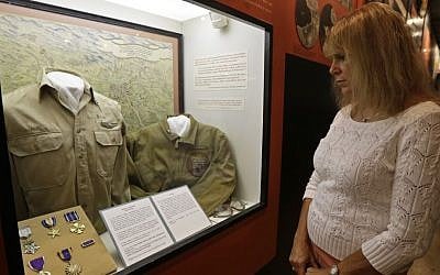 Karen Warner views a display on the Ploesti Raid in World War II that shows a shirt worn by her father, Lt. Col. Jack Warner, while touring the United States Air Force Museum, Wednesday, July 31, 2013, in Dayton, Ohio. (photo credit: AP Photo/Al Behrman)