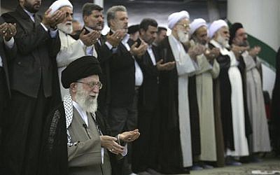 Iranian Supreme Leader Ayatollah Ali Khamenei, front row left, leads the Eid al-Fitr prayer, marking the start in Iran of the Eid al-Fitr holiday Aug. 9, 2013 (AP Photo/Office of the Iranian Supreme Leader)