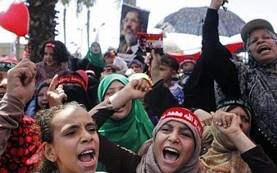 Supporters of Egypt's ousted President Mohammed Morsi shout slogans in Nahda square, where protesters installed their camp near Cairo University in Giza, southwest of Cairo, Egypt, Friday, Aug. 9, 2013 (photo credit: AP/Amr Nabil)