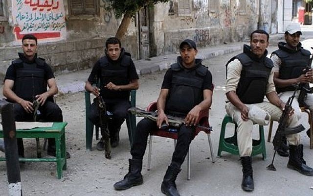 Egyptian security forces taking a break in Beni Sueif, south of Cairo, Egypt, on Friday (photo credit: AP/Sabry Khaled/El-Shorouk) Egyptian security forces taking a break in Beni Sueif, south of Cairo, Egypt, on Friday (photo credit: AP/Sabry Khaled/El-Shorouk)