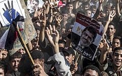 Supporters of the Muslim Brotherhood chant slogans during a demonstration in Dalga Village, in upper Egypt, Aug. 30, 2013 (photo credit: AP/Roger Anis/El Shorouk Newspaper)