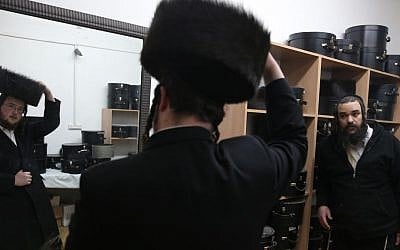 Illustrative photo of a man trying on a shtreimel in the ultra-Orthodox neighborhood of Mea Shearim, Jerusalem. (photo credit: Nati Shohat/Flash90)