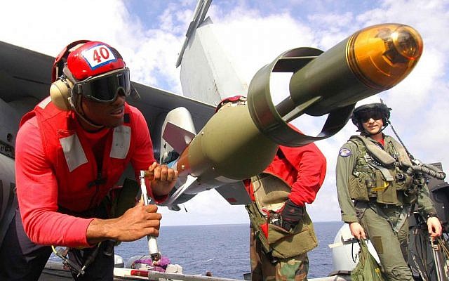 Airman Harold Doe tightens a bolt on a computer-guided inert practice bomb loaded on an F/A-18 Hornet aircraft on the flight deck of the aircraft carrier USS Dwight D. Eisenhower as the ship operates in the Mediterranean Sea on Oct. 23, 2006. (photo credit: Petty Officer 2nd Class Miguel Angel Contreras/US Navy, Department of Defense) Airman Harold Doe tightens a bolt on a computer-guided inert practice bomb loaded on an F/A-18 Hornet aircraft on the flight deck of the aircraft carrier USS Dwight D. Eisenhower as the ship operates in the Mediterranean Sea on Oct. 23, 2006. (photo credit: Petty Officer 2nd Class Miguel Angel Contreras/US Navy, Department of Defense)