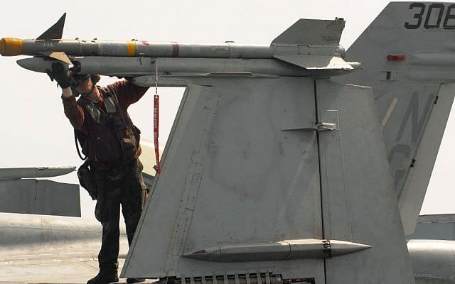 A Navy officer checking an AIM-9 Sidewinder missile for proper mounting on an F/A-18C Hornet aircraft, prior to flight operations aboard the aircraft carrier USS John C. Stennis in 2007. (photo credit: Seaman Josue Leopoldo Escobosa/ US Navy/Department of Defense). A Navy officer checking an AIM-9 Sidewinder missile for proper mounting on an F/A-18C Hornet aircraft, prior to flight operations aboard the aircraft carrier USS John C. Stennis in 2007. (photo credit: Seaman Josue Leopoldo Escobosa/ US Navy/Department of Defense).