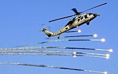 A US MH-60S Seahawk helicopter launches flares during a drill in the skies above the aircraft carrier USS Abraham Lincoln in the Mediterranean Sea on July 25, 2012. (photo credit: Seaman Joshua E. Walters/ US Navy, Department of Defense)
