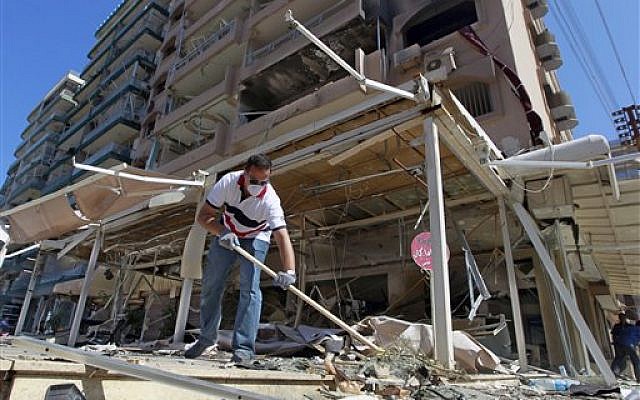 A Lebanese man cleans his damaged shop at the site of a car bomb explosion outside of the Salam mosque in the northern city of Tripoli, Lebanon, Saturday, Aug. 24, 2013 (photo credit: AP/Bilal Hussein) A Lebanese man cleans his damaged shop at the site of a car bomb explosion outside of the Salam mosque in the northern city of Tripoli, Lebanon, Saturday, Aug. 24, 2013 (photo credit: AP/Bilal Hussein)
