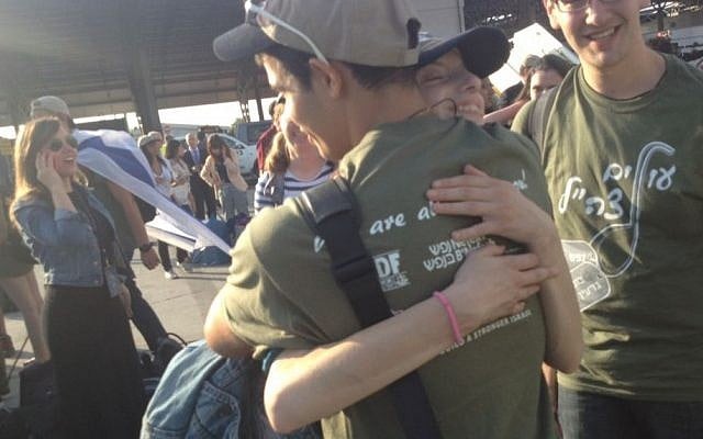 New immigrants hugging upon arrival to Israel. (photo credit: Joshua Davidovich/TimesofIsrael)