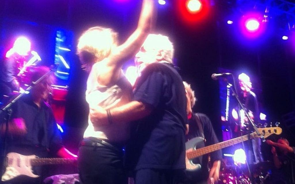 Eric Burdon dances with an enthusiastic fan who climbed up on stage early in his show at the Zappa Shuni Amphitheater in Binyamina on Thursday night. (photo credit: ToI staff) Eric Burdon dances with an enthusiastic fan who climbed up on stage early in his show at the Zappa Shuni Amphitheater in Binyamina on Thursday night. (photo credit: ToI staff)