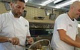 Assaf Granit (left) and Tomer Ballas of Lechem shel Tomer, serving up chickpeas and meat patties on day 17 of the FoodTrip (photo credit: Jessica Steinberg/Times of Israel)