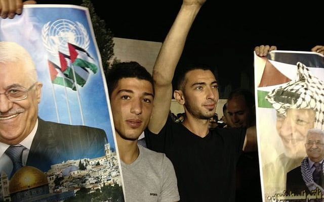 Young Palestinians celebrate the release of 11 prisoners to the West Bank early Wednesday, August 14. (photo credit: Elhanan Miller/Times of Israel)