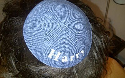 One Direction star Harry Styles sports a kippah bearing his name, a gift reportedly given to him by director Ben Winston. (Photo credit: Twitter)