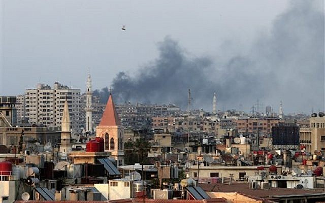Columns of smoke rising from heavy shelling in the Jobar neighborhood in west Damascus, in Cairo, Syria, Thursday, Aug. 22, 2013 (photo credit: AP/Hassan Ammar) Columns of smoke rising from heavy shelling in the Jobar neighborhood in west Damascus, in Cairo, Syria, Thursday, Aug. 22, 2013 (photo credit: AP/Hassan Ammar)