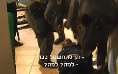 Image of Boaz Albert getting arrested by police. The subtitles read 'Give him the electricity already' and 'Why? Why?' (photo credit: YouTube screen capture)