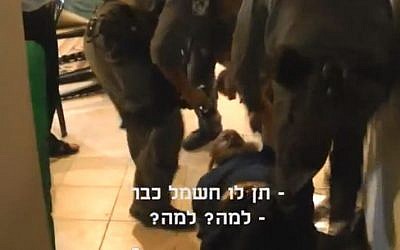 Image of Boaz Albert getting arrested by police. The subtitles read 'Give him the electricity already' and 'Why? Why?' (photo credit: YouTube screen capture)