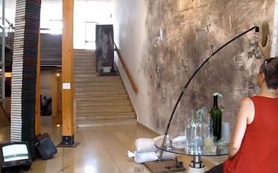 Art installation in Ein Hod that allows one to fling shoes at Finance Minister Yair Lapid in exchange for drinks.(photo credit: screen capture/YouTube)