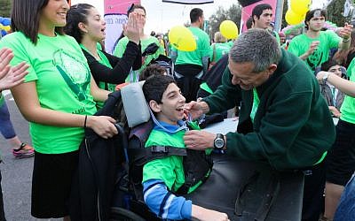 Doron Almog puts a medal on a child from ALEH Jerusalem at the Jerusalem Marathon (photo credit: courtesy Aleh) Doron Almog puts a medal on a child from ALEH Jerusalem at the Jerusalem Marathon (photo credit: courtesy Aleh)