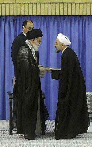 In this picture released by the official website of the Iranian supreme leader's office, Supreme Leader Ayatollah Ali Khamenei, left, gives his official seal of approval to President-elect Hasan Rouhani, in an official endorsement ceremony, in Tehran, Iran, Saturday, Aug. 3, 2013. (photo credit: AP Photo/Office of the Iranian Supreme Leader)