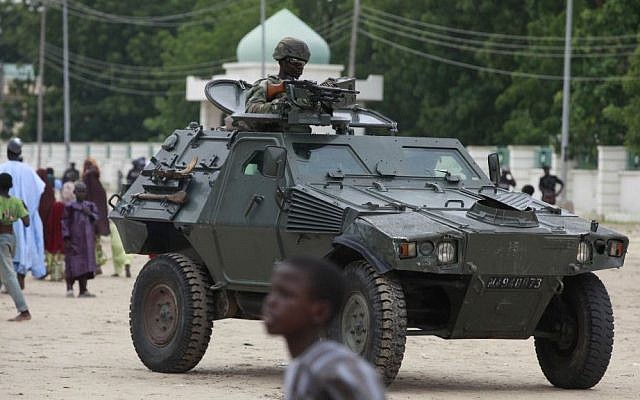 Illutrative photo of Nigerian soldiers in an armored vehicle following a terrorist attack, August 2013 (photo credit: AP/Sunday Alamba/File) Illutrative photo of Nigerian soldiers in an armored vehicle following a terrorist attack, August 2013 (photo credit: AP/Sunday Alamba/File)