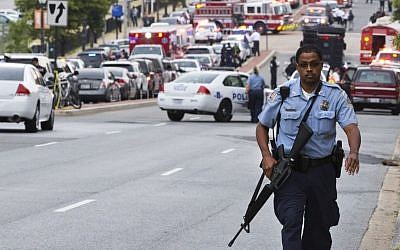 In a 2013 attack, a police officer walks near the Washington Navy Yard after at least one gunman launched a deadly attack inside the heavily secured military installation (photo credit: AP/Jacquelyn Martin)