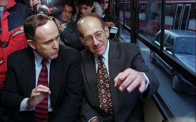 New York mayor Rudy Giuliani, left, gestures as he rides Jerusalem's bus No. 18 with Jerusalem's mayor Ehud Olmert, on a visit in 1996. (AP/Brian Hendler)