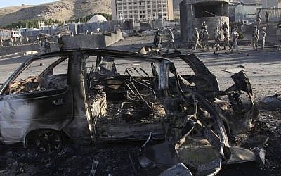 Afghan security personnel investigate the site of a suicide car bombing and a gunfight near the US Consulate in Herat Province, west of Kabul, Afghanistan, on Friday (photo credit: AP/Hoshang Hashimi)
