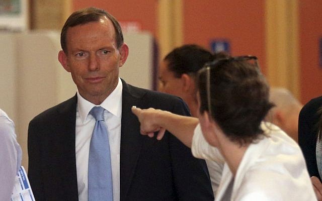 A woman points at Australia's opposition leader Tony Abbott while he waits to cast his vote at Freshwater Surf Life Saving Club polling station in Sydney, Australia, Saturday, Sept. 7, 2013. (photo credit: AP/Rob Griffith) A woman points at Australia's opposition leader Tony Abbott while he waits to cast his vote at Freshwater Surf Life Saving Club polling station in Sydney, Australia, Saturday, Sept. 7, 2013. (photo credit: AP/Rob Griffith)